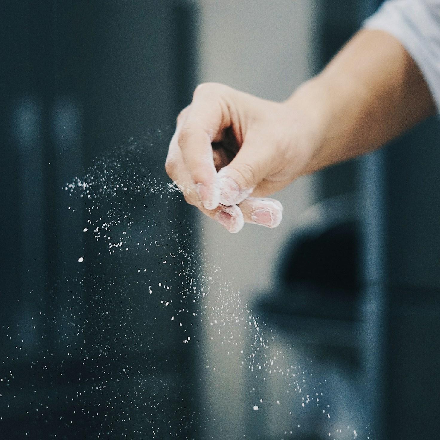 Community members collaborating in a contemporary kitchen, exchange recipes and techniques